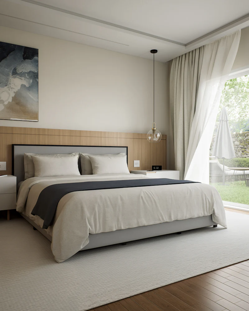 Ein modernes Schlafzimmer mit großem Bett und Blick in den Garten